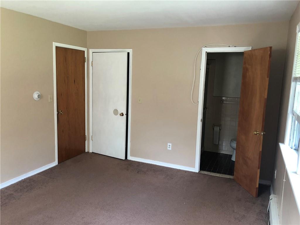236 Creek Road Poughkeepsie, NY 12601 - Photo 17 of 18 Unfurnished bedroom featuring a baseboard radiator, ensuite bath, and dark carpet