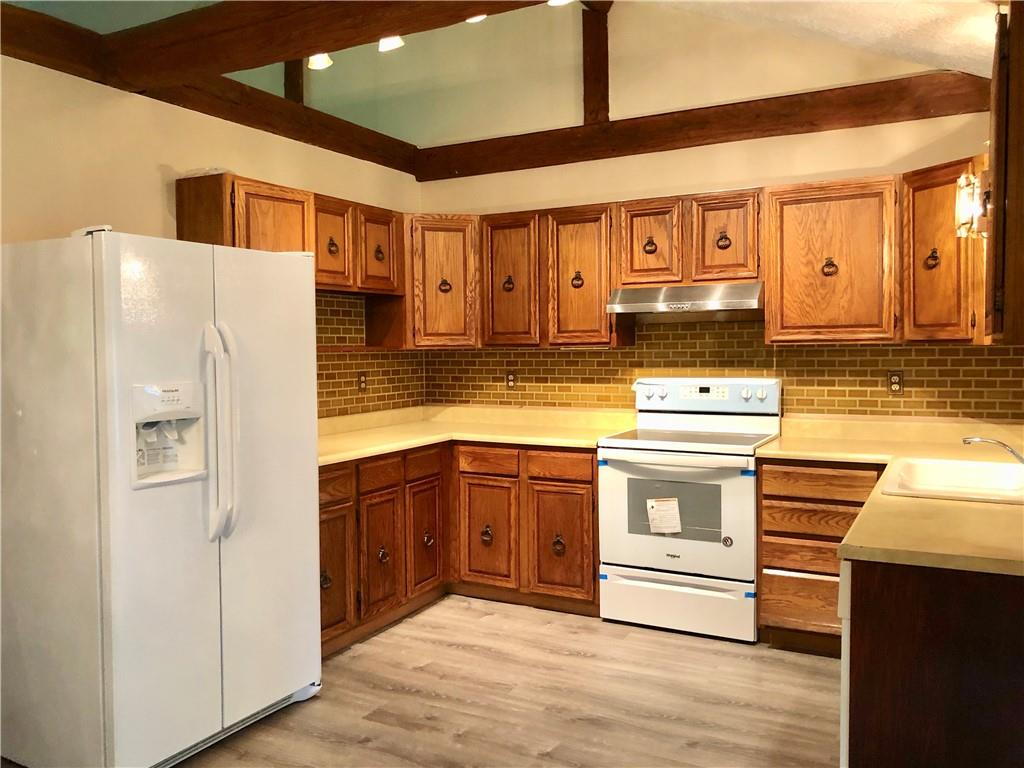 236 Creek Road Poughkeepsie, NY 12601 - Photo 4 of 18 Kitchen featuring sink, light hardwood / wood-style flooring, tasteful backsplash, and white appliances