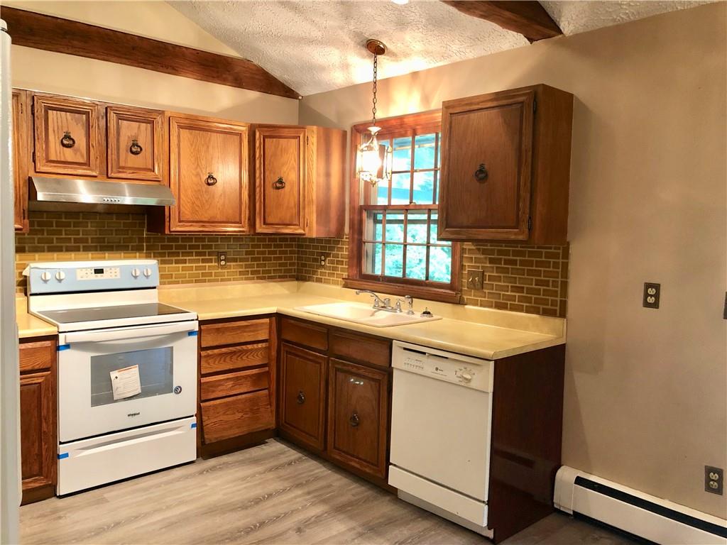 236 Creek Road Poughkeepsie, NY 12601 - Photo 5 of 18 Kitchen featuring white appliances, vaulted ceiling, sink, light hardwood / wood-style floors, and baseboard heating