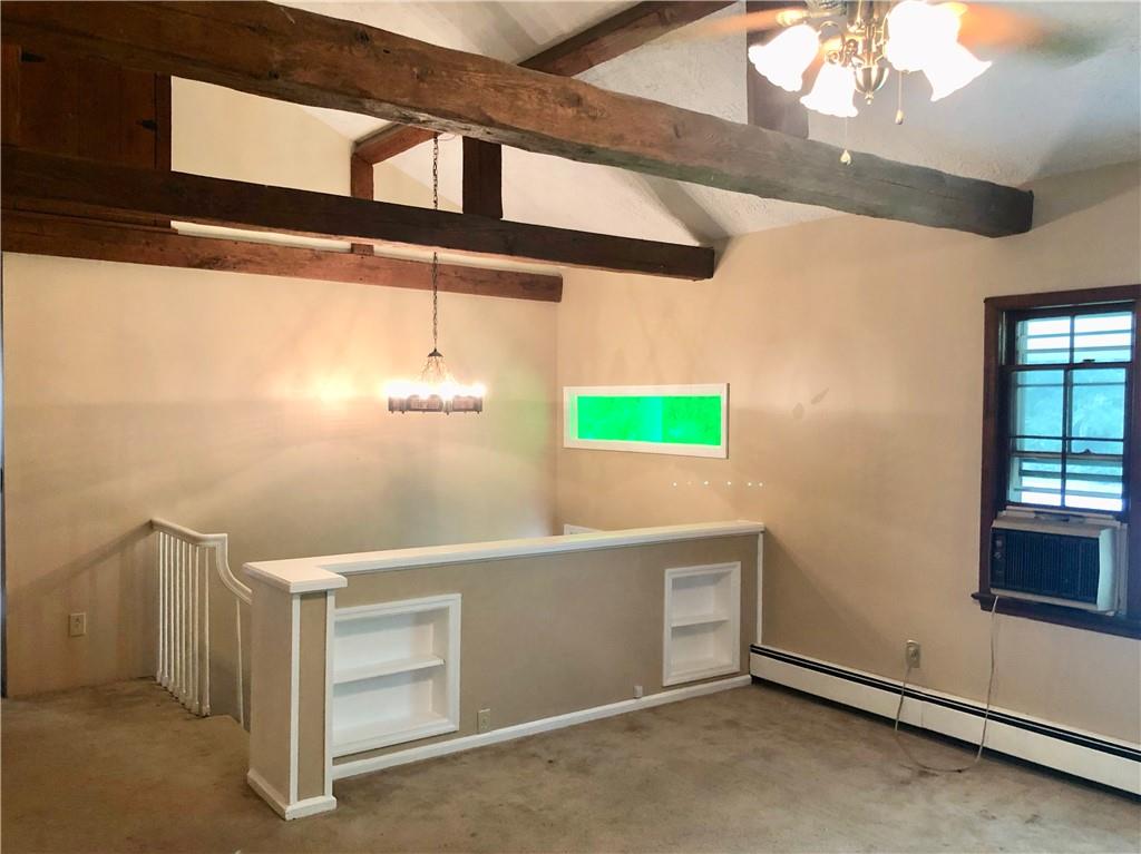 236 Creek Road Poughkeepsie, NY 12601 - Photo 7 of 18 Carpeted spare room featuring vaulted ceiling with beams, cooling unit, ceiling fan with notable chandelier, and baseboard heating