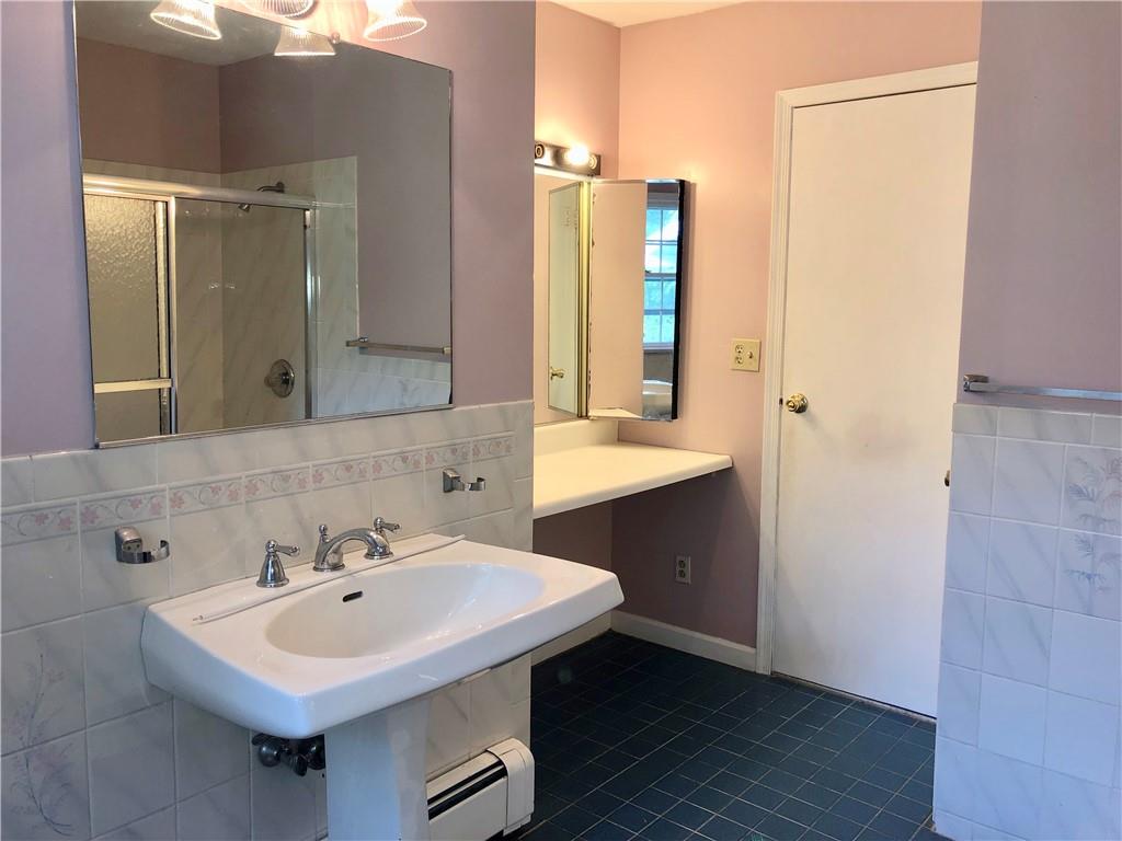 236 Creek Road Poughkeepsie, NY 12601 - Photo 10 of 18 Bathroom featuring tile patterned flooring, tile walls, baseboard heating, and backsplash
