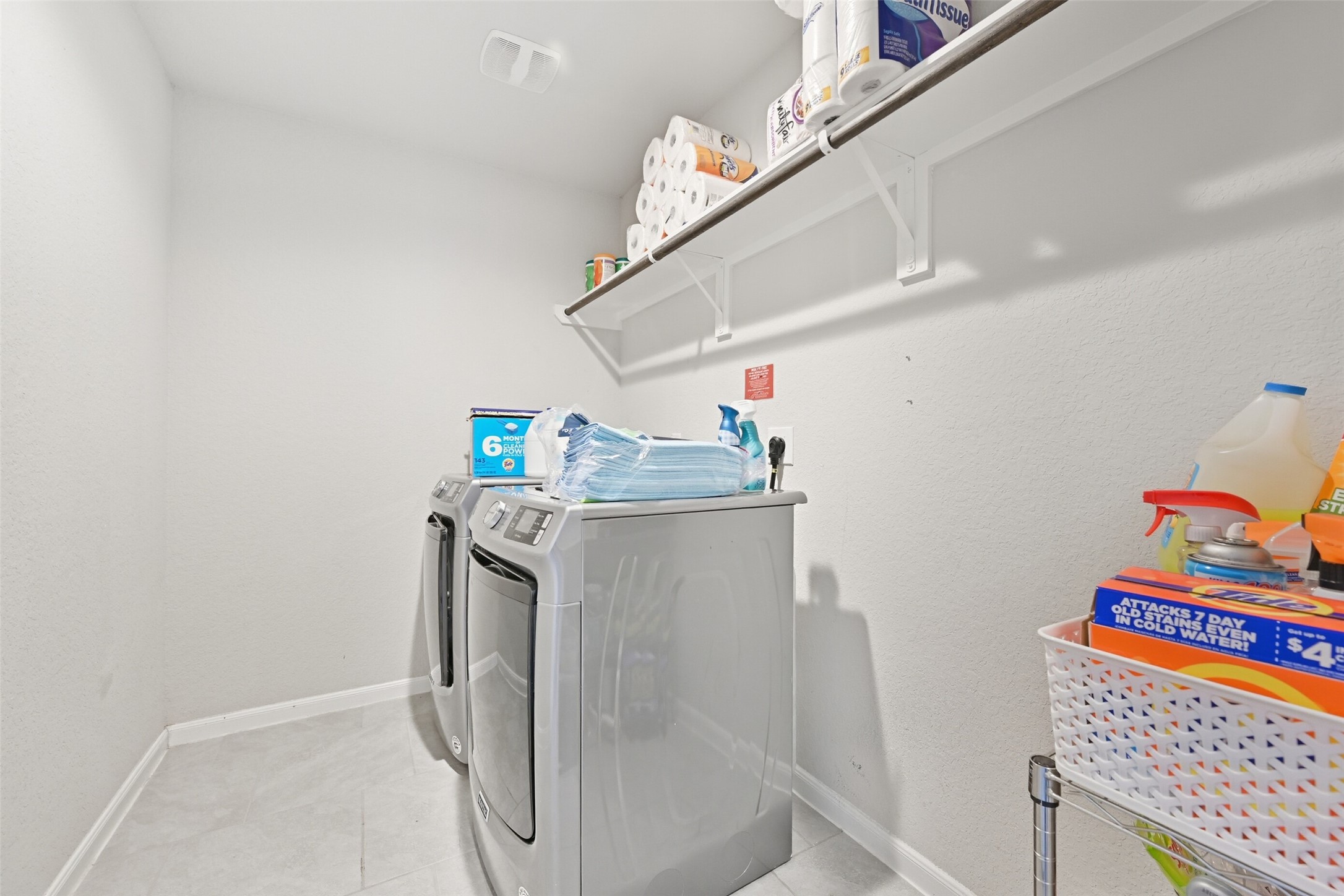 714 Calm Court Rosharon, TX 77583 - Photo 28 of 33 Utility room with shelving and space for full-size washer and dryer.