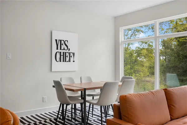 a view of a dining room with furniture large window and outside view