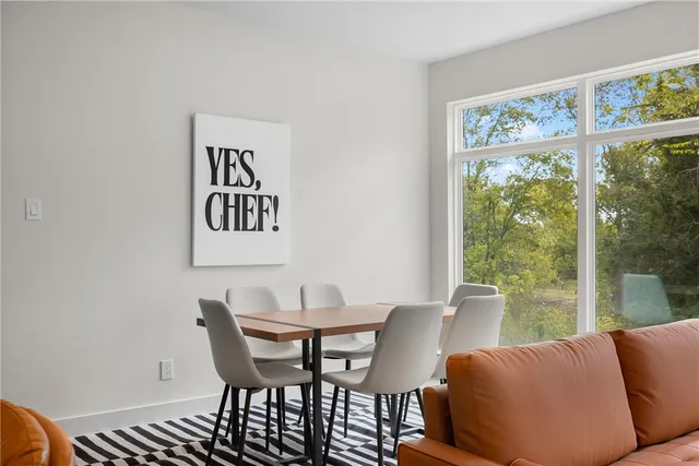 a view of a dining room with furniture large window and outside view