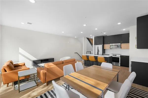 a group of kitchen with a table and chairs