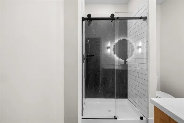 a bathroom with a glass shower door