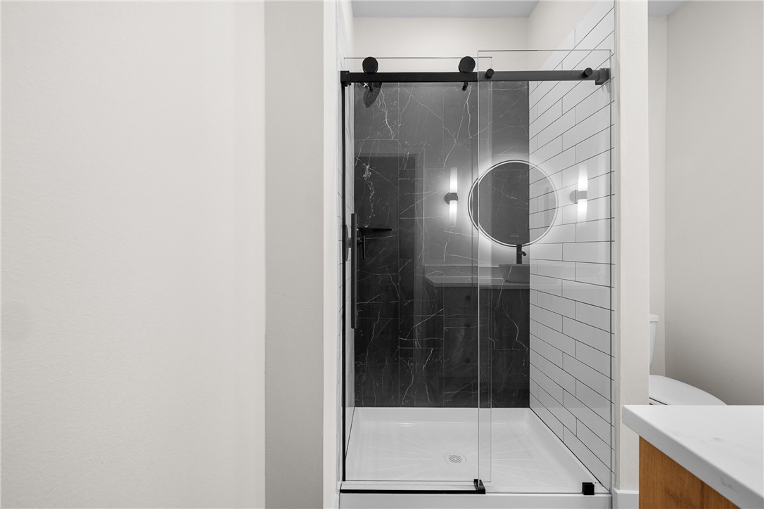 2539 East Villa Maria Road, Unit 11D Bryan, TX 77802 - Photo 20 of 38 a bathroom with a glass shower door