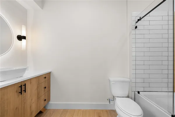 a white toilet sitting next to a bathroom sink