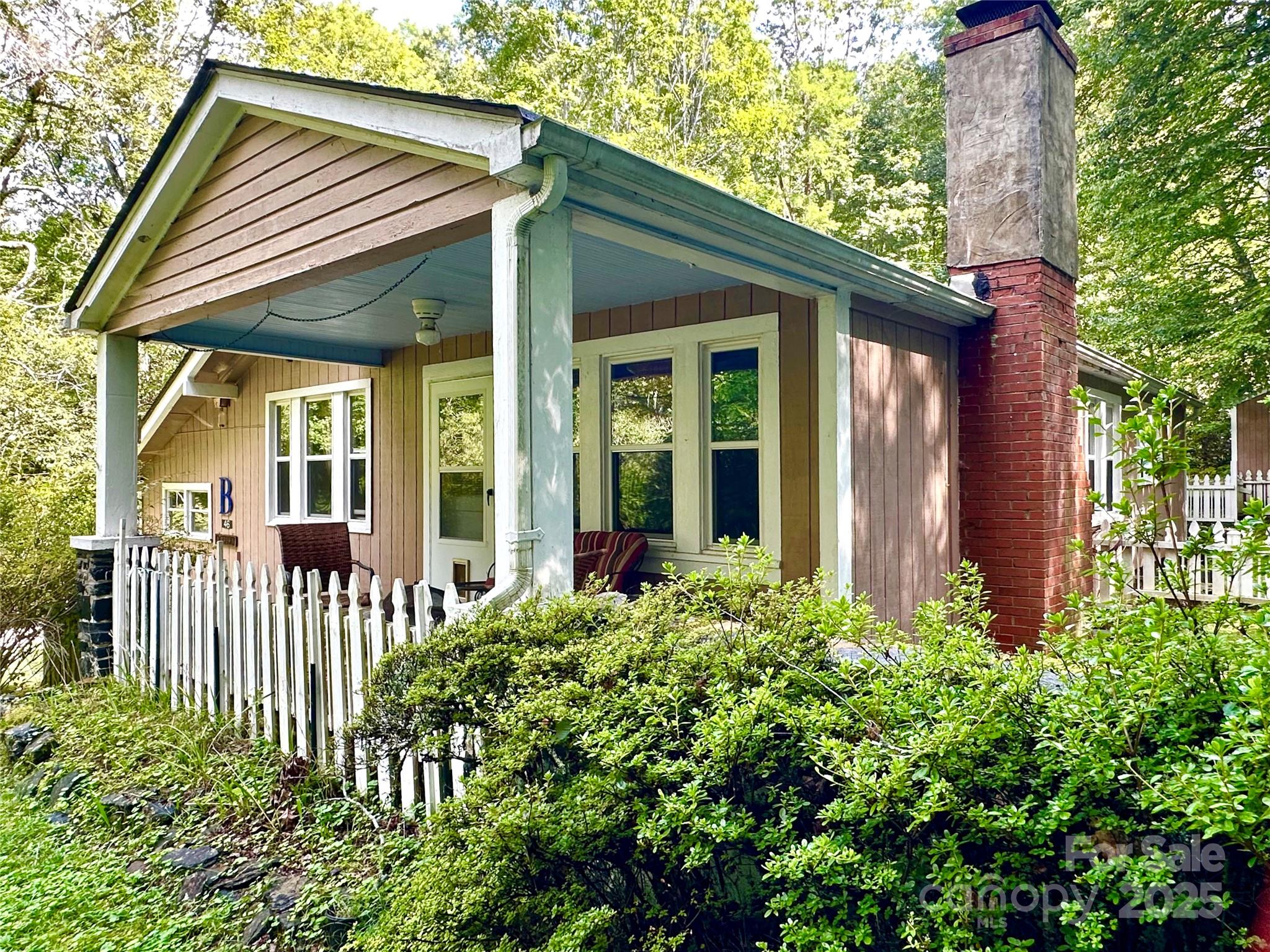 a view of a house with a flower garden