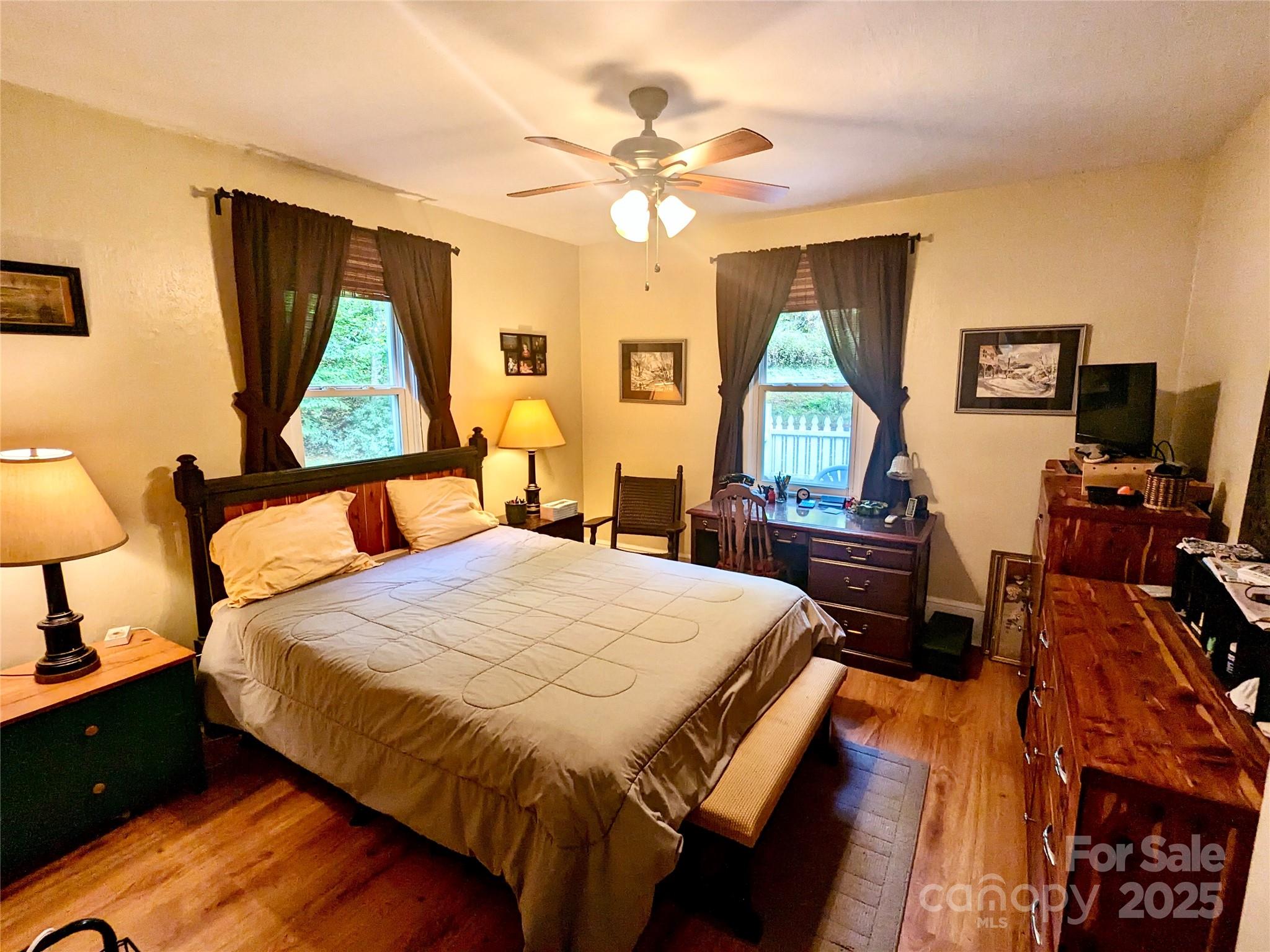 46 Tree Farm Road Spruce Pine, NC 28777 - Photo 15 of 40 a bedroom with a bed and a chandelier