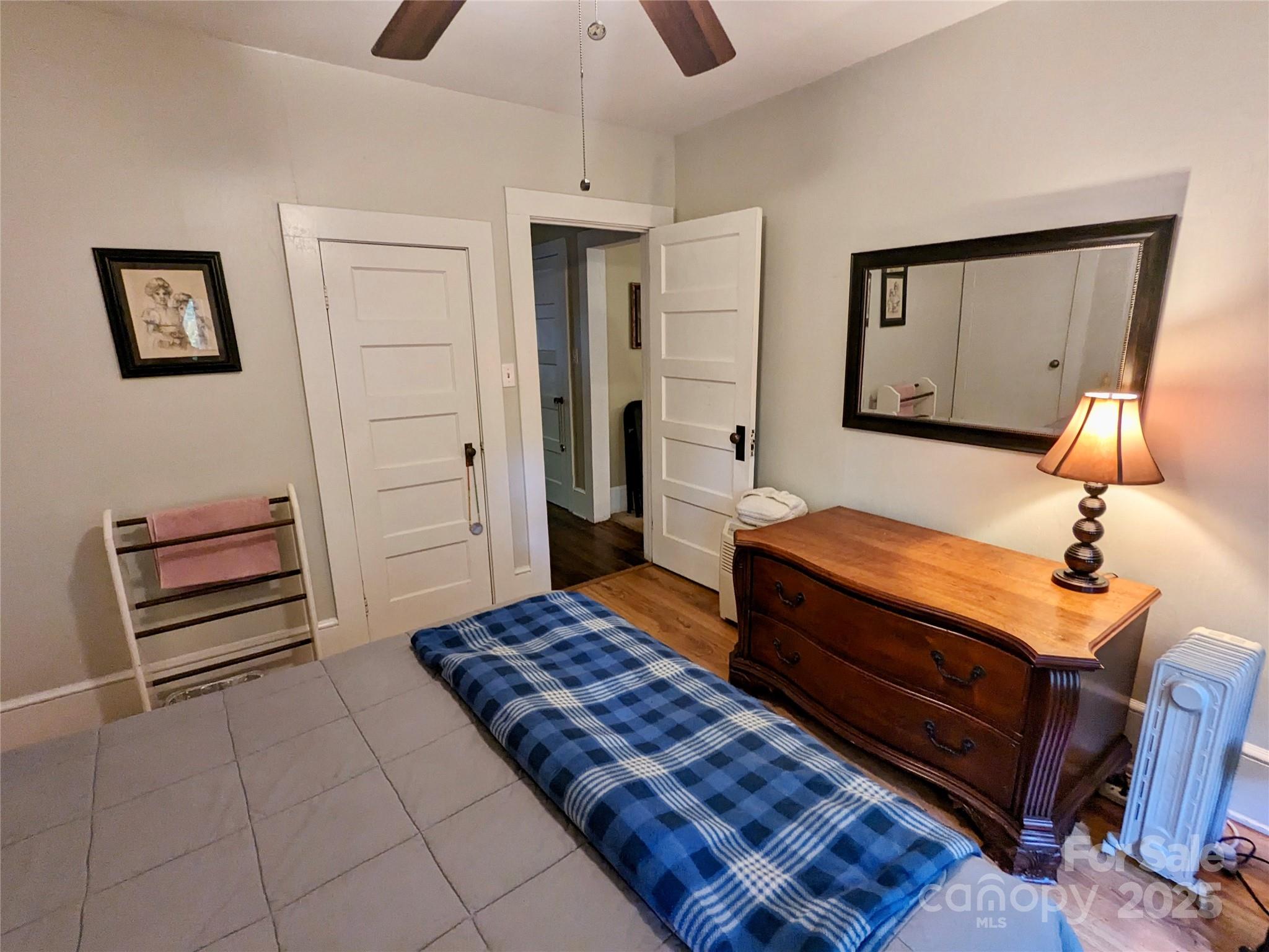 46 Tree Farm Road Spruce Pine, NC 28777 - Photo 16 of 40 a bedroom with a bed and wooden floor