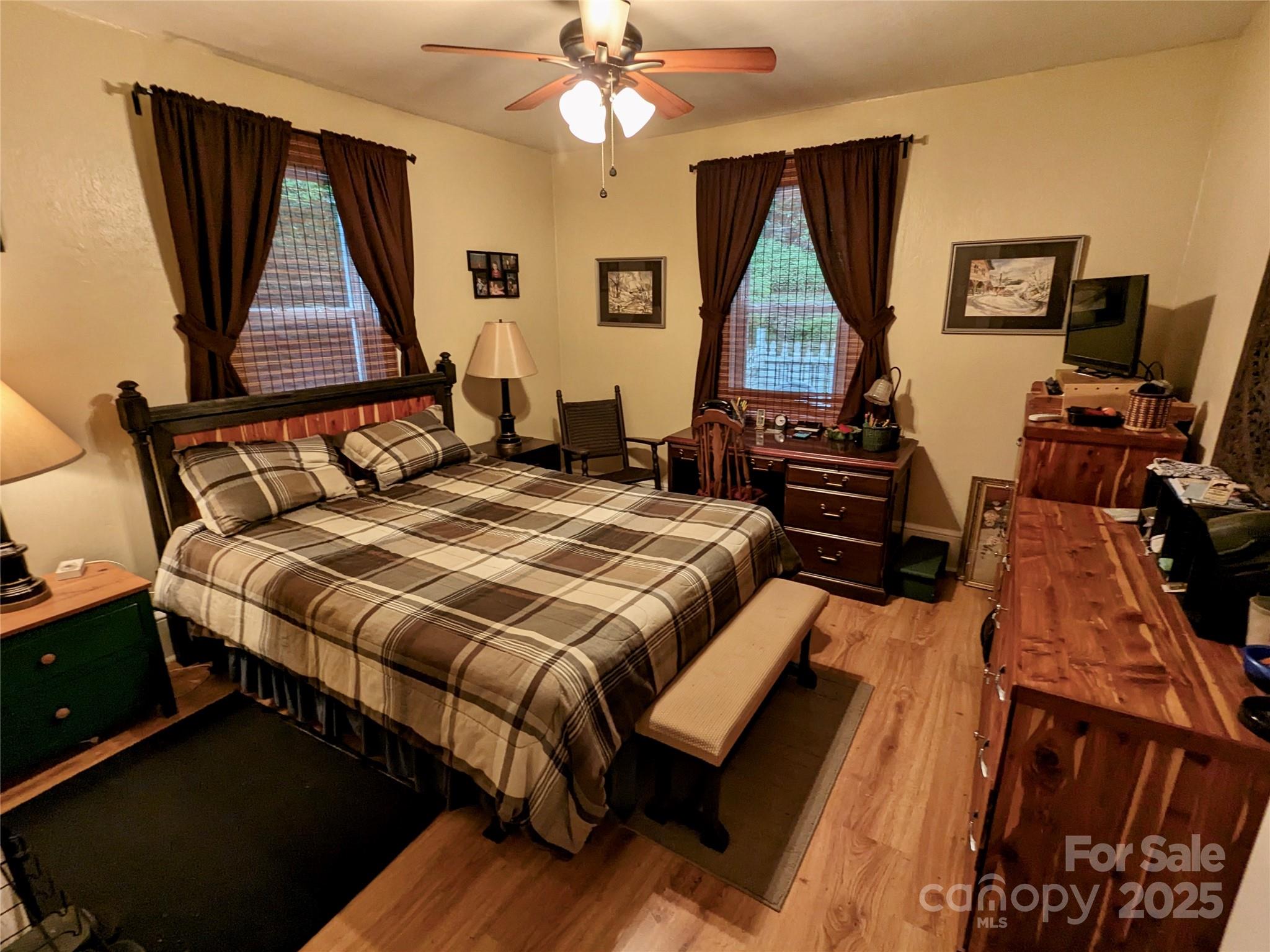 46 Tree Farm Road Spruce Pine, NC 28777 - Photo 22 of 40 a bedroom with a bed a dresser and flat screen tv