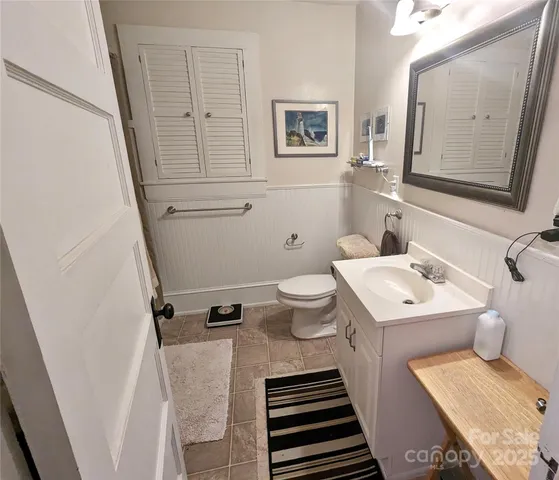 a bathroom with a sink toilet and mirror