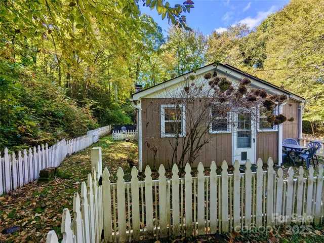 a view of a house with wooden fence