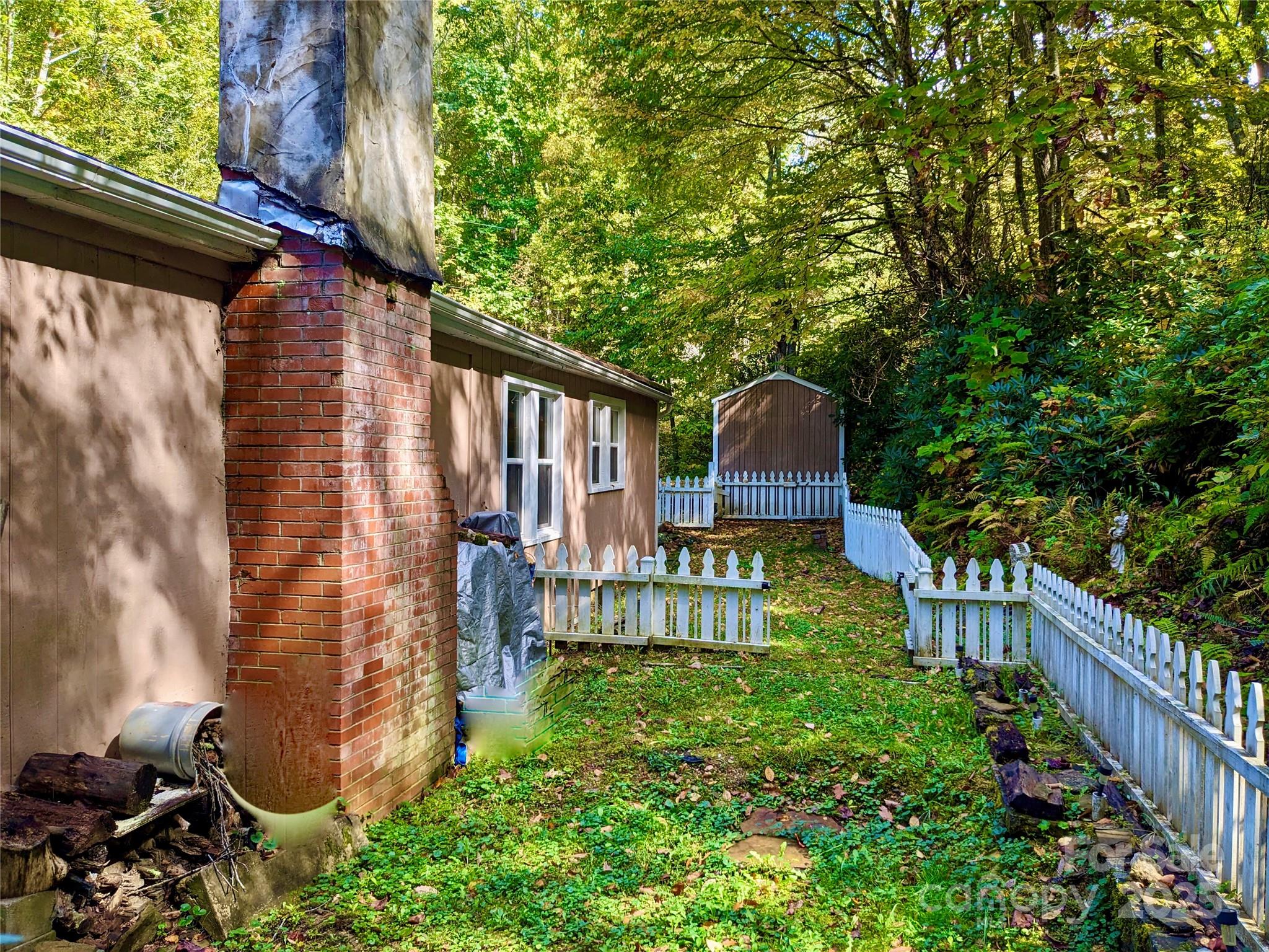 46 Tree Farm Road Spruce Pine, NC 28777 - Photo 29 of 40 a backyard of a house with lots of green space