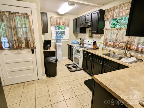 a kitchen with stainless steel appliances kitchen island granite countertop a sink and cabinets
