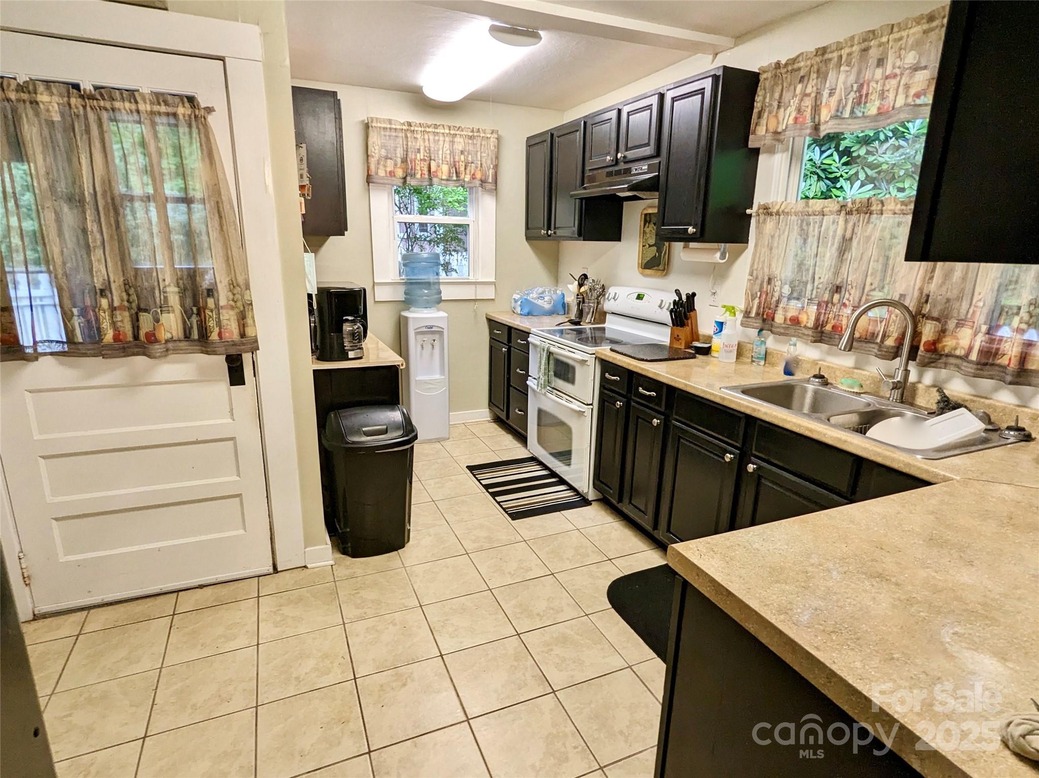 46 Tree Farm Road Spruce Pine, NC 28777 - Photo 3 of 40 a kitchen with stainless steel appliances kitchen island granite countertop a sink and cabinets