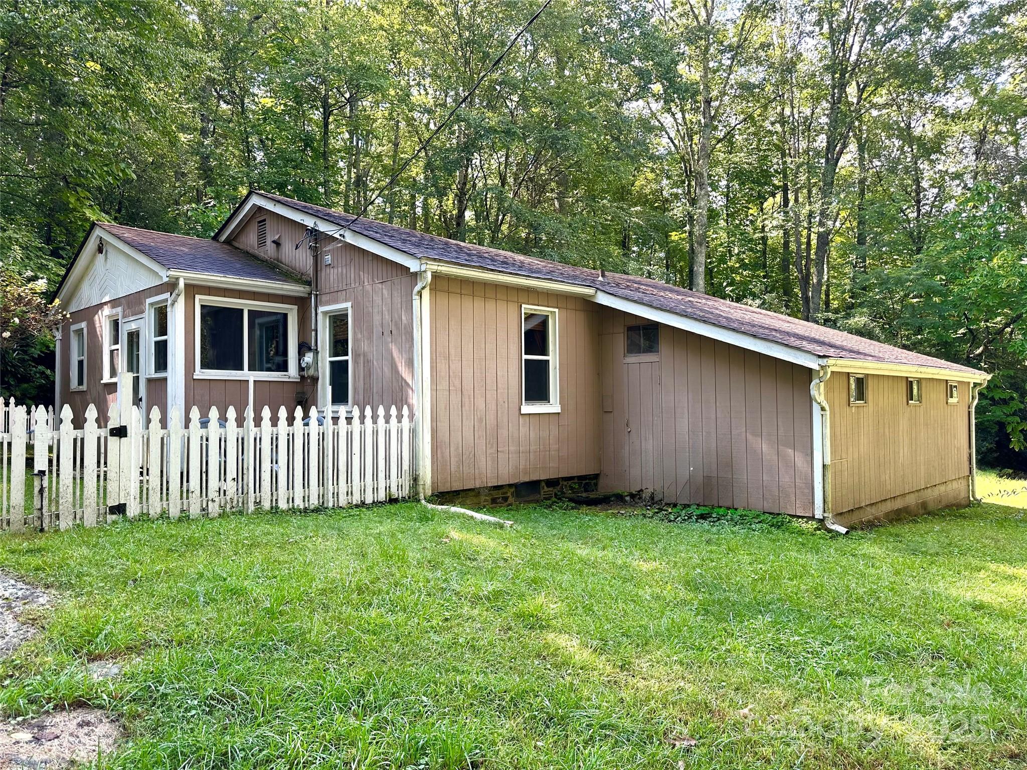 46 Tree Farm Road Spruce Pine, NC 28777 - Photo 37 of 40 a front view of a house with a yard