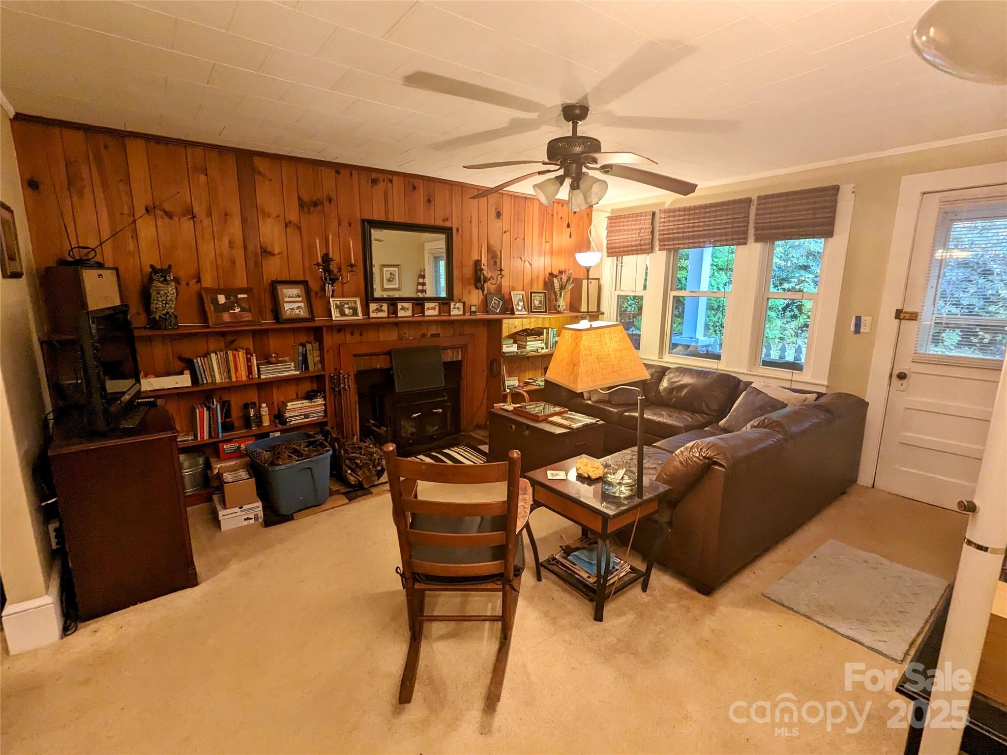 46 Tree Farm Road Spruce Pine, NC 28777 - Photo 8 of 40 a living room with furniture a fireplace and a flat screen tv