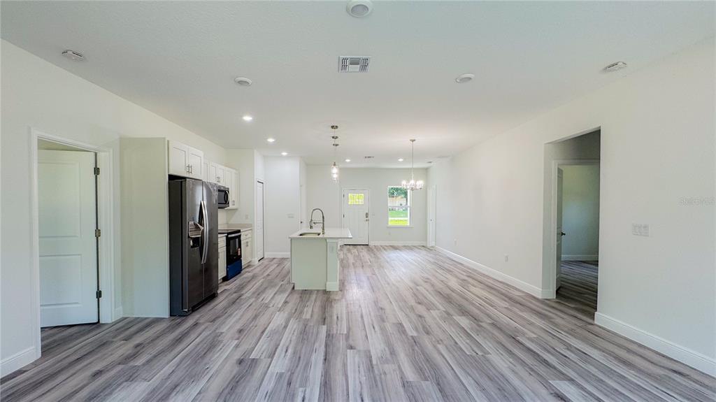 15625 Southwest 37th Circle Ocala, FL 34473 - Photo 7 of 27 a view of a big room with wooden floor and windows