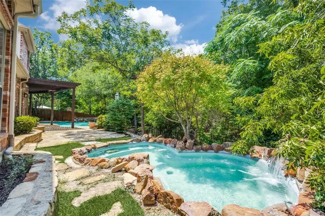 a view of a backyard with table and chairs and potted plants
