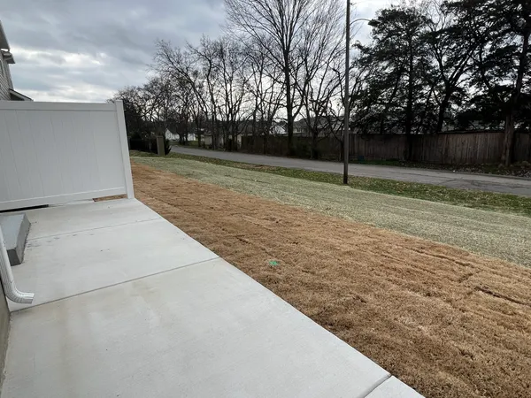 an empty room with a ceiling fan and window