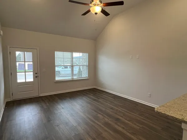 a kitchen with stainless steel appliances granite countertop a sink counter space cabinets and wooden floor