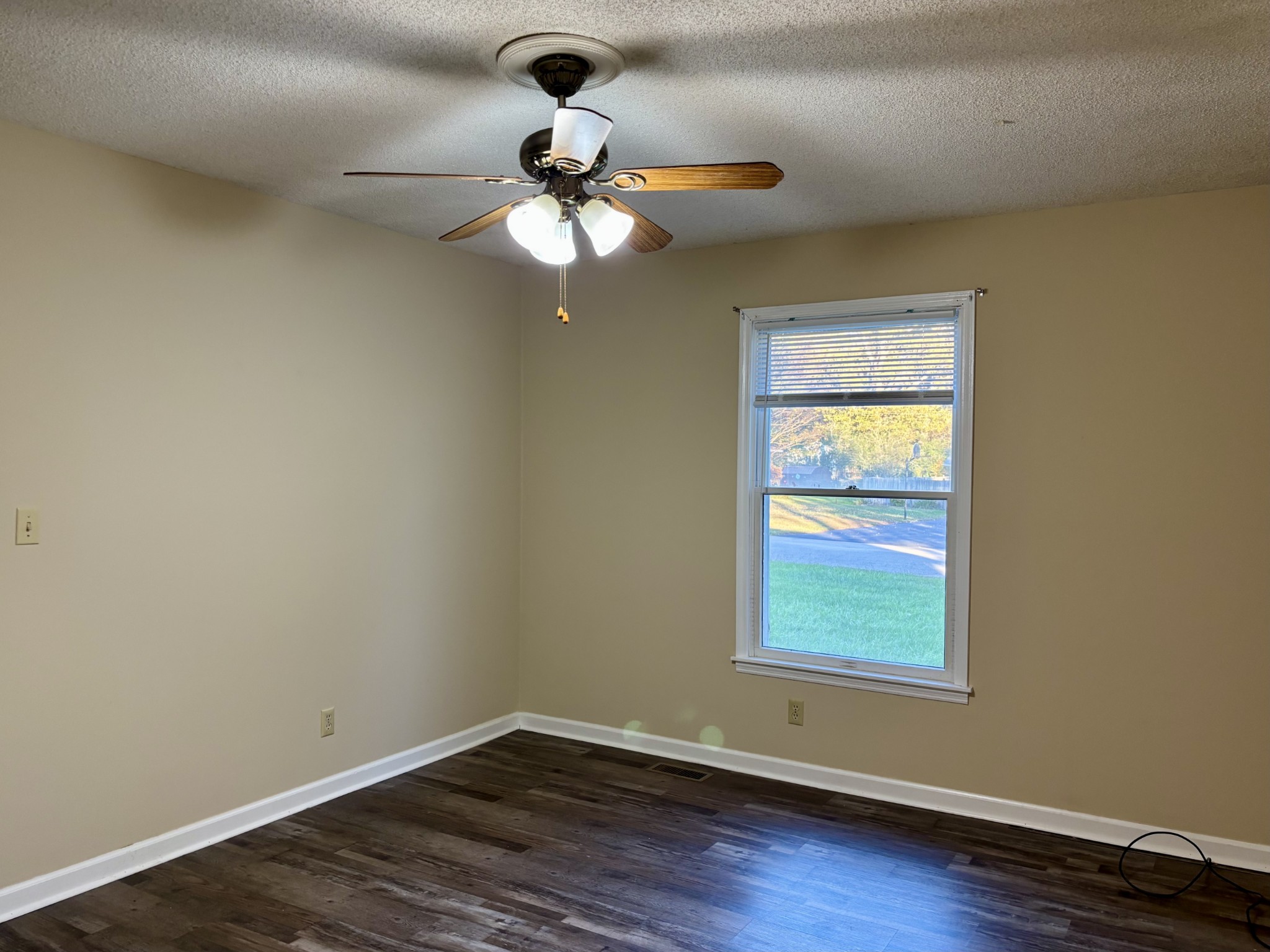 218 Greenfield Avenue Tullahoma, TN 37388 - Photo 8 of 14 a view of an empty room with wooden floor and a window