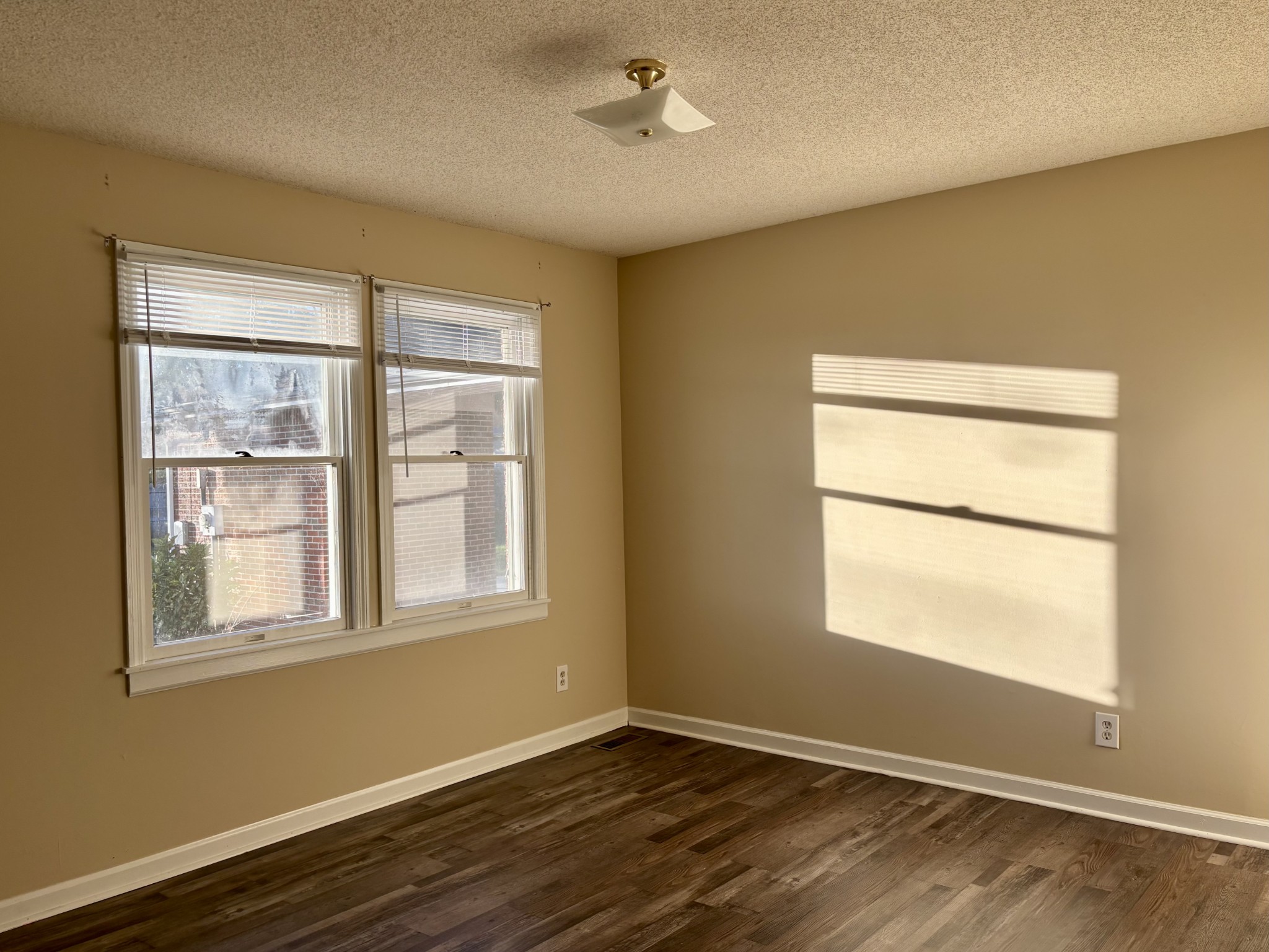 218 Greenfield Avenue Tullahoma, TN 37388 - Photo 10 of 14 a view of an empty room with wooden floor and a window