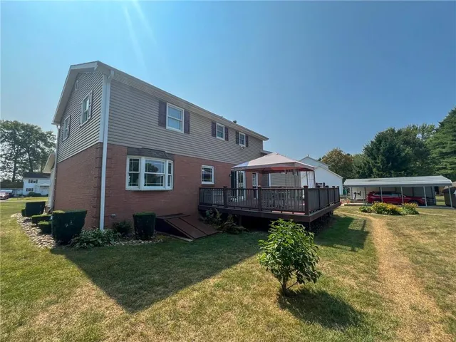 a backyard of a house with garden and trees