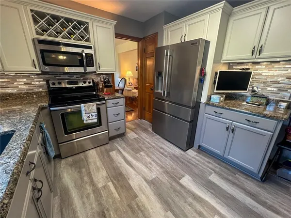 a kitchen with a refrigerator stove and microwave