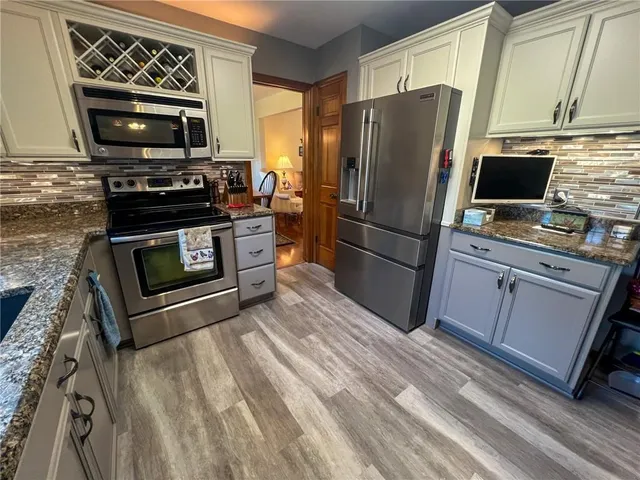 a kitchen with a refrigerator stove and microwave