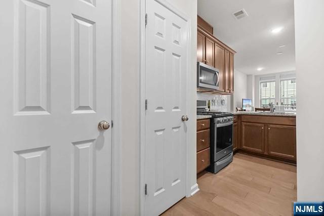 54 Arnold Drive Wood-Ridge, NJ 07075 - Photo 16 of 40 a kitchen with stainless steel appliances granite countertop a refrigerator a sink dishwasher and a stove