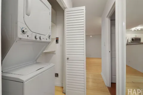 a living room with fireplace furniture and a large window
