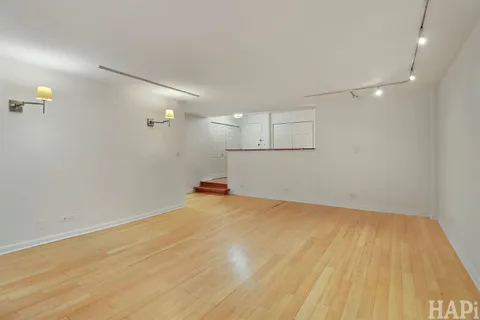 a view of a room with wooden floor and white walls