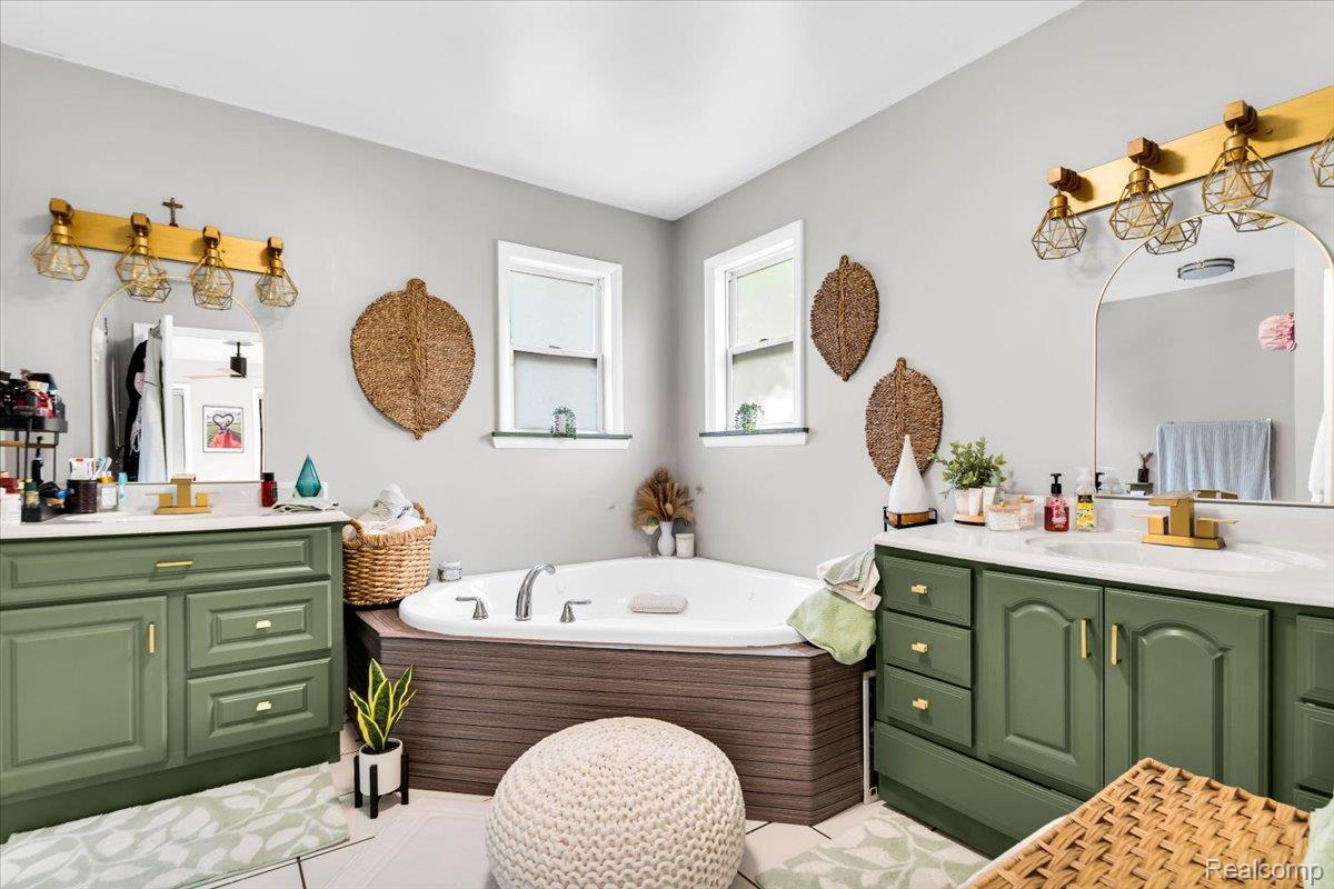 3260 Isabelle Street Inkster, MI 48141 - Photo 18 of 35 Corner soaking tub with a wood-finish surround, flanked by two windows