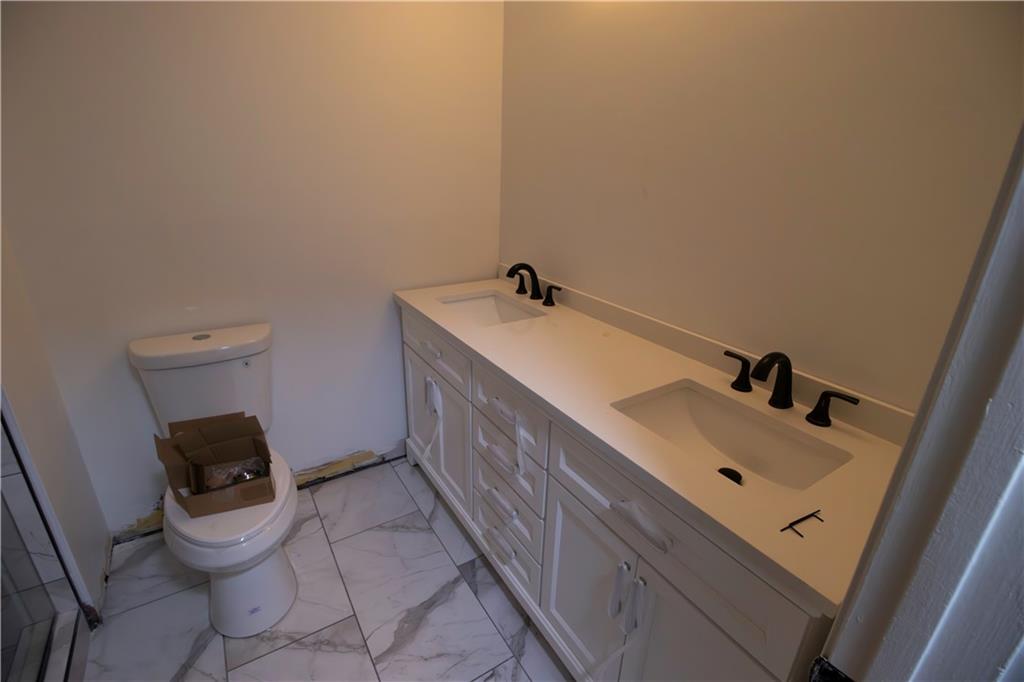 1292 Monfort Road Lawrenceville, GA 30046 - Photo 9 of 48 a bathroom with a sink and a toilet