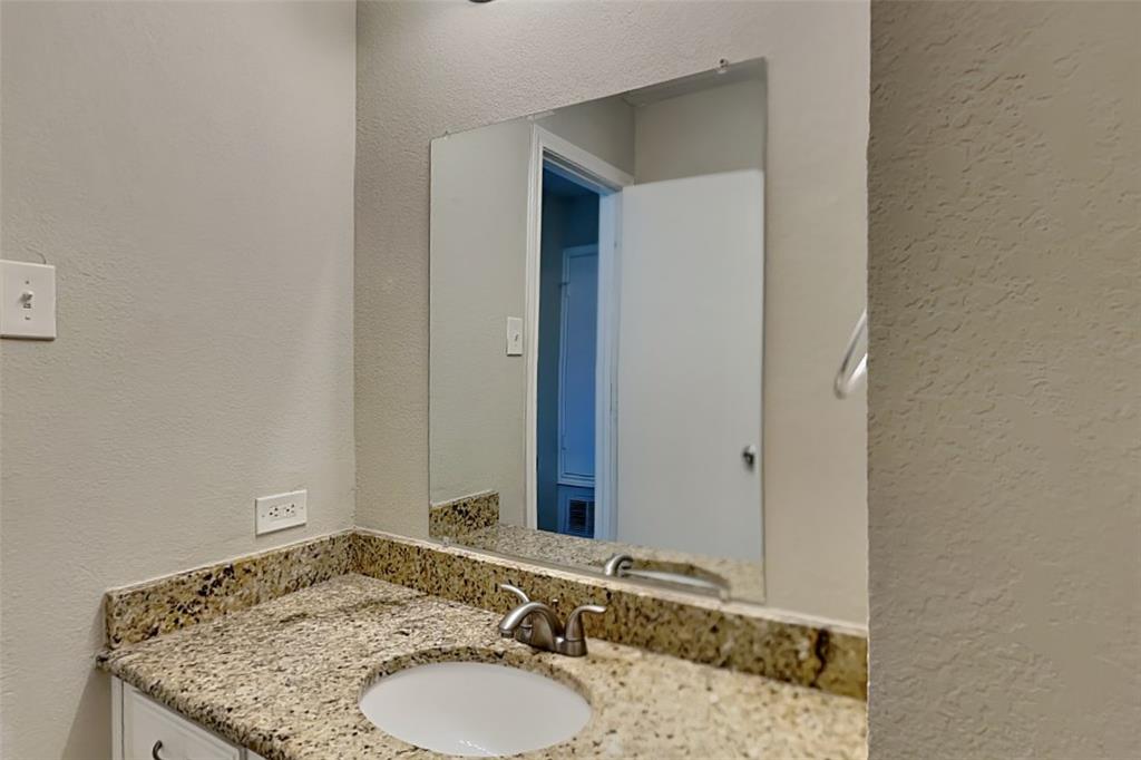 508 Rawhide Court Plano, TX 75023 - Photo 15 of 19 a bathroom with a granite countertop sink and a mirror