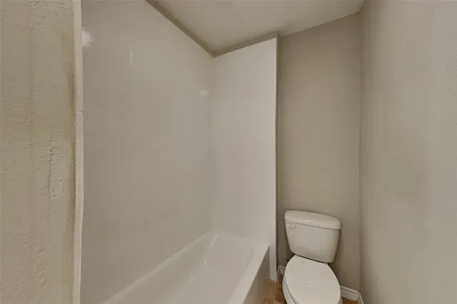 a white toilet sitting next to a white sink