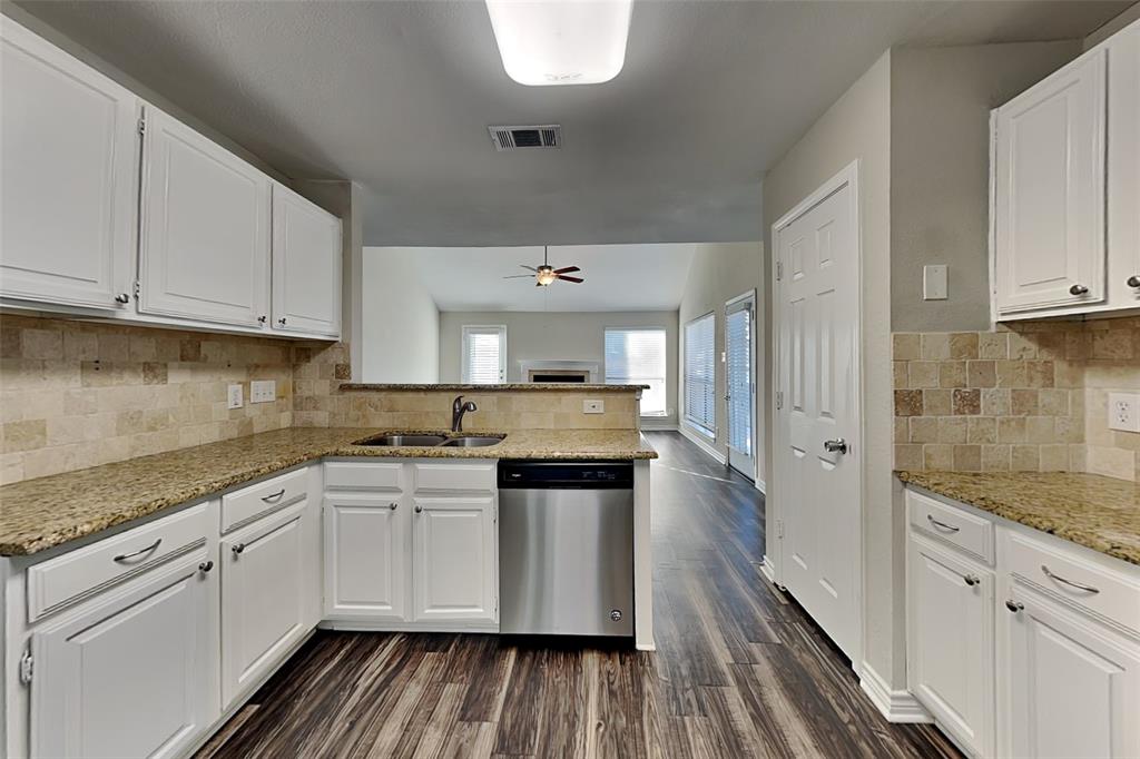 508 Rawhide Court Plano, TX 75023 - Photo 4 of 19 a kitchen with a sink stove and cabinets