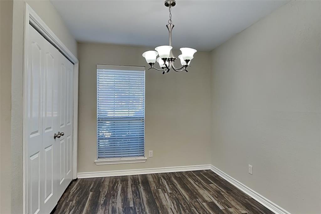 508 Rawhide Court Plano, TX 75023 - Photo 5 of 19 a view of a room with window wooden floor and a ceiling fan