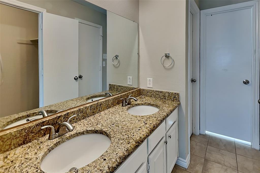 508 Rawhide Court Plano, TX 75023 - Photo 10 of 19 a bathroom with a granite countertop sink and a mirror