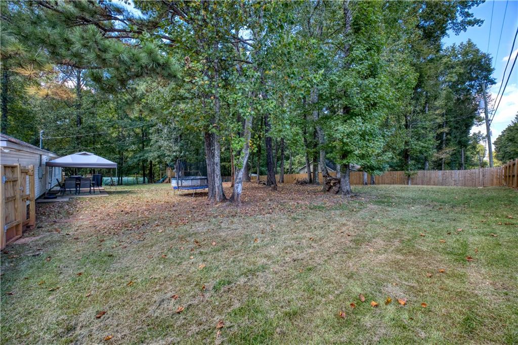 25 Lee Road Salem, AL 36874 - Photo 22 of 30 Fenced backyard with a trampoline