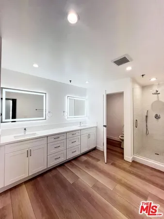 a large bathroom with a double vanity sink and a mirror