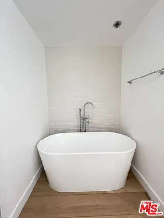 a white bath tub sitting in a bathroom