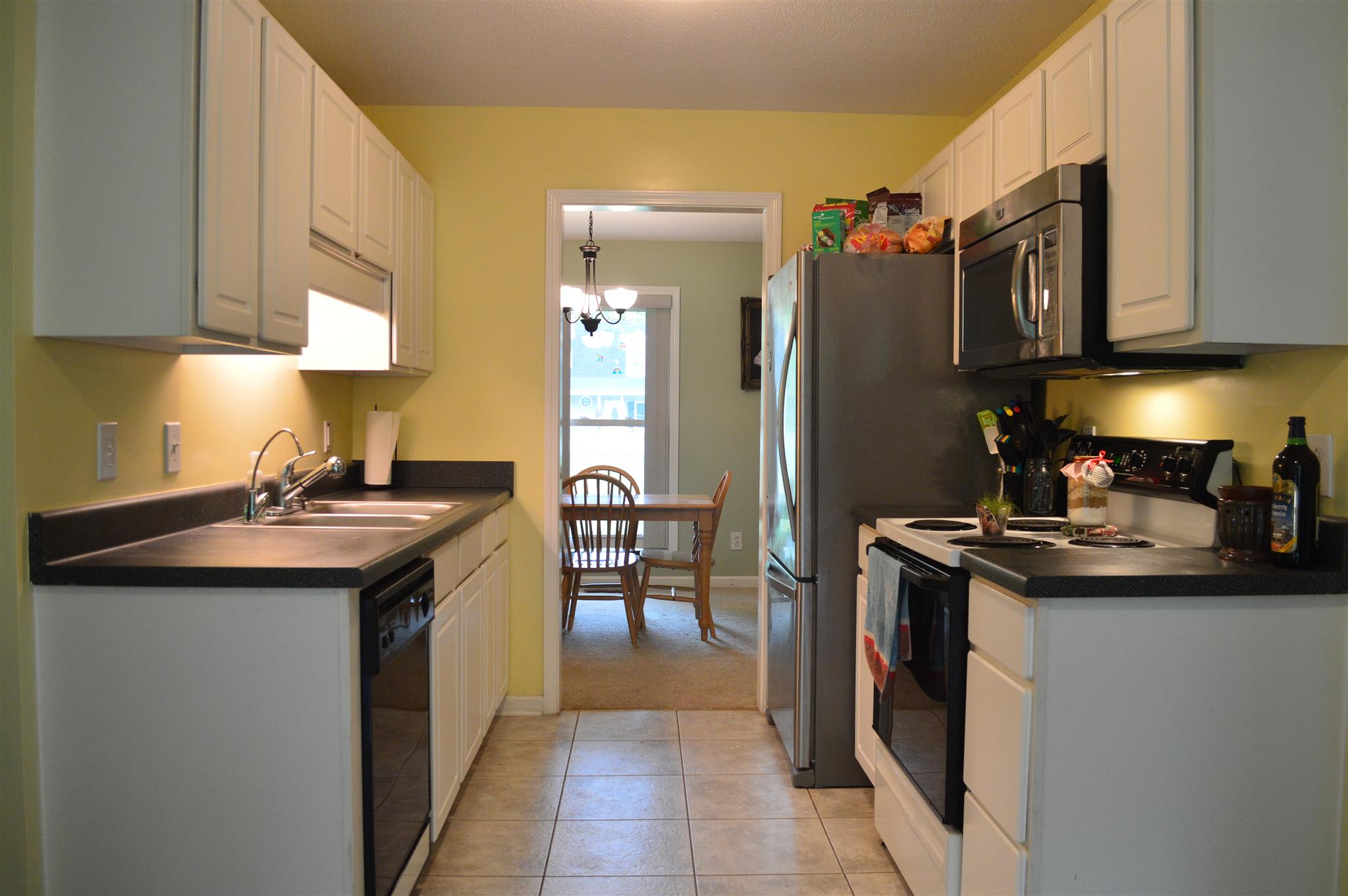 3361 Backridge Road Woodlawn, TN 37191 - Photo 10 of 30 a kitchen with stainless steel appliances granite countertop a sink a stove and a refrigerator