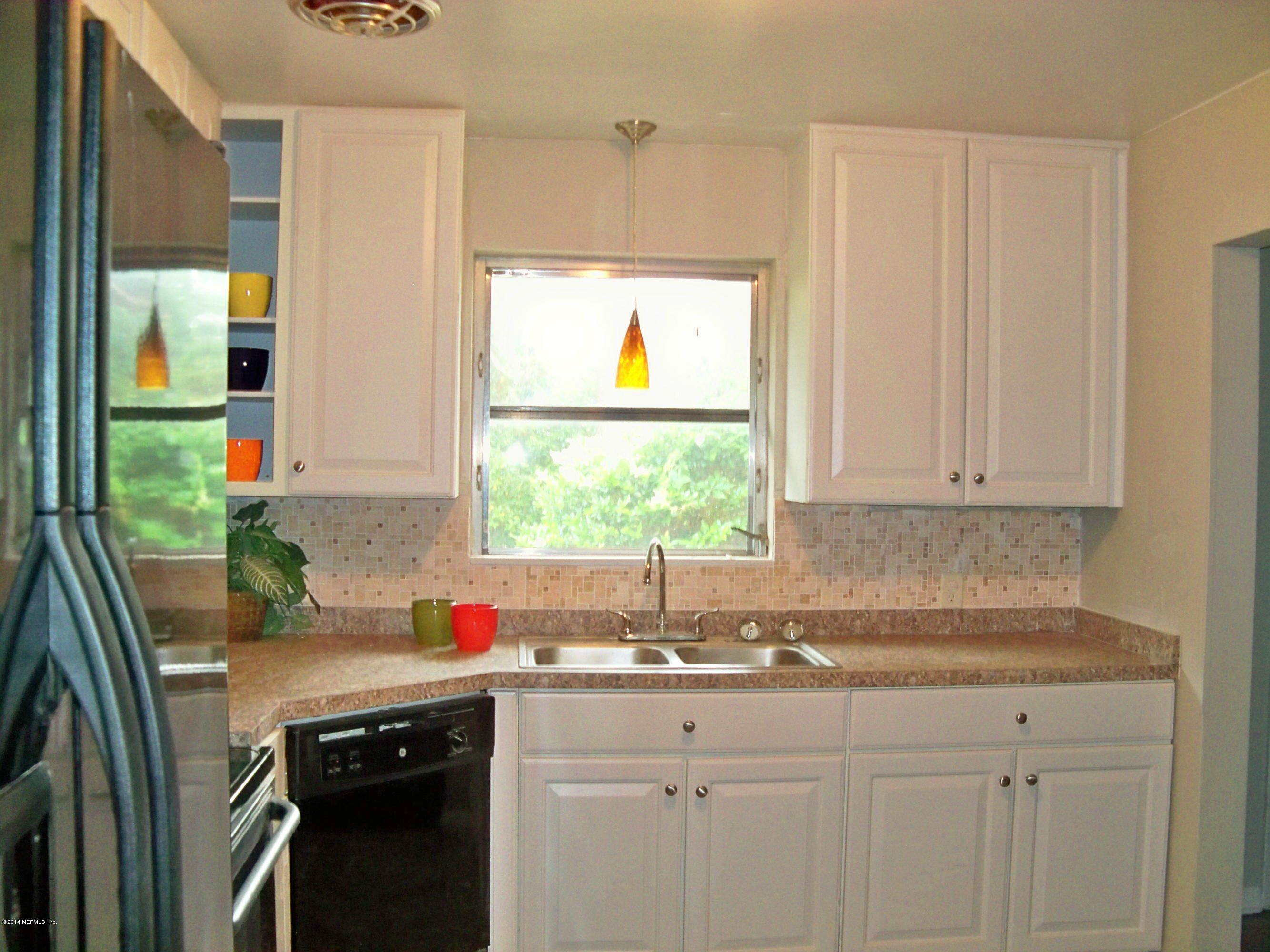 3219 Rogero Road Jacksonville, FL 32277 - Photo 7 of 13 a kitchen with stainless steel appliances a sink next to a window