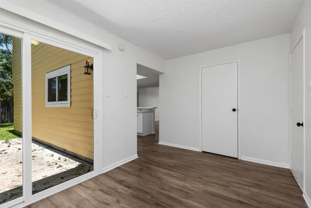 a view of a livingroom with wooden floor and a ceiling fan