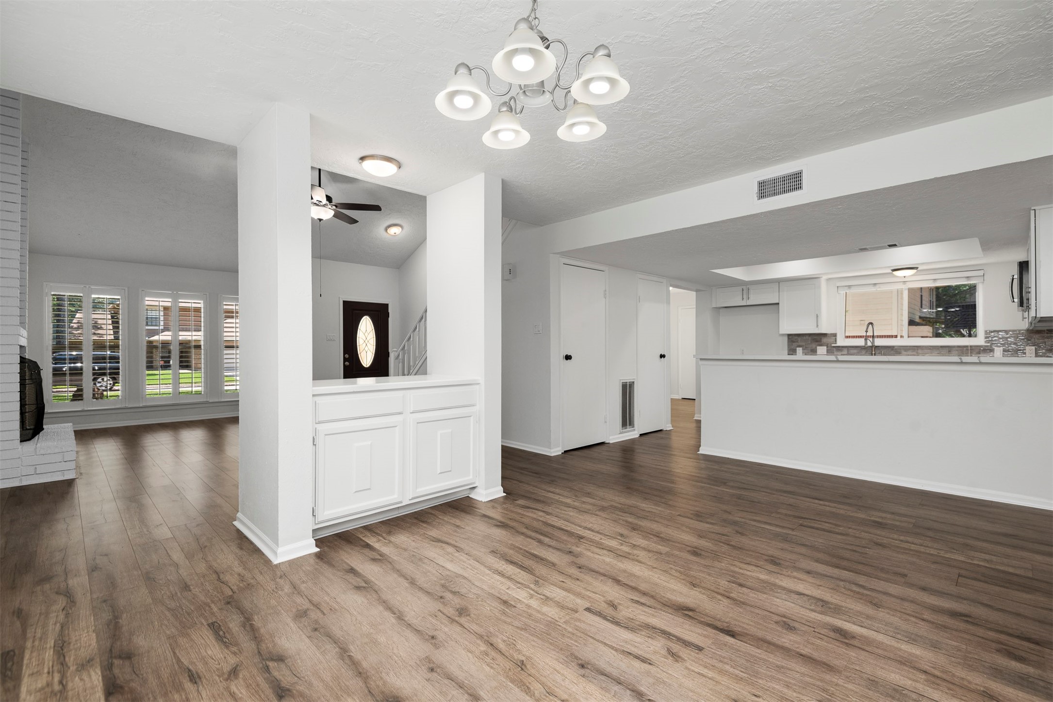 30 Berryfrost Lane The Woodlands, TX 77380 - Photo 14 of 33 a view of a kitchen with wooden floor and a large window