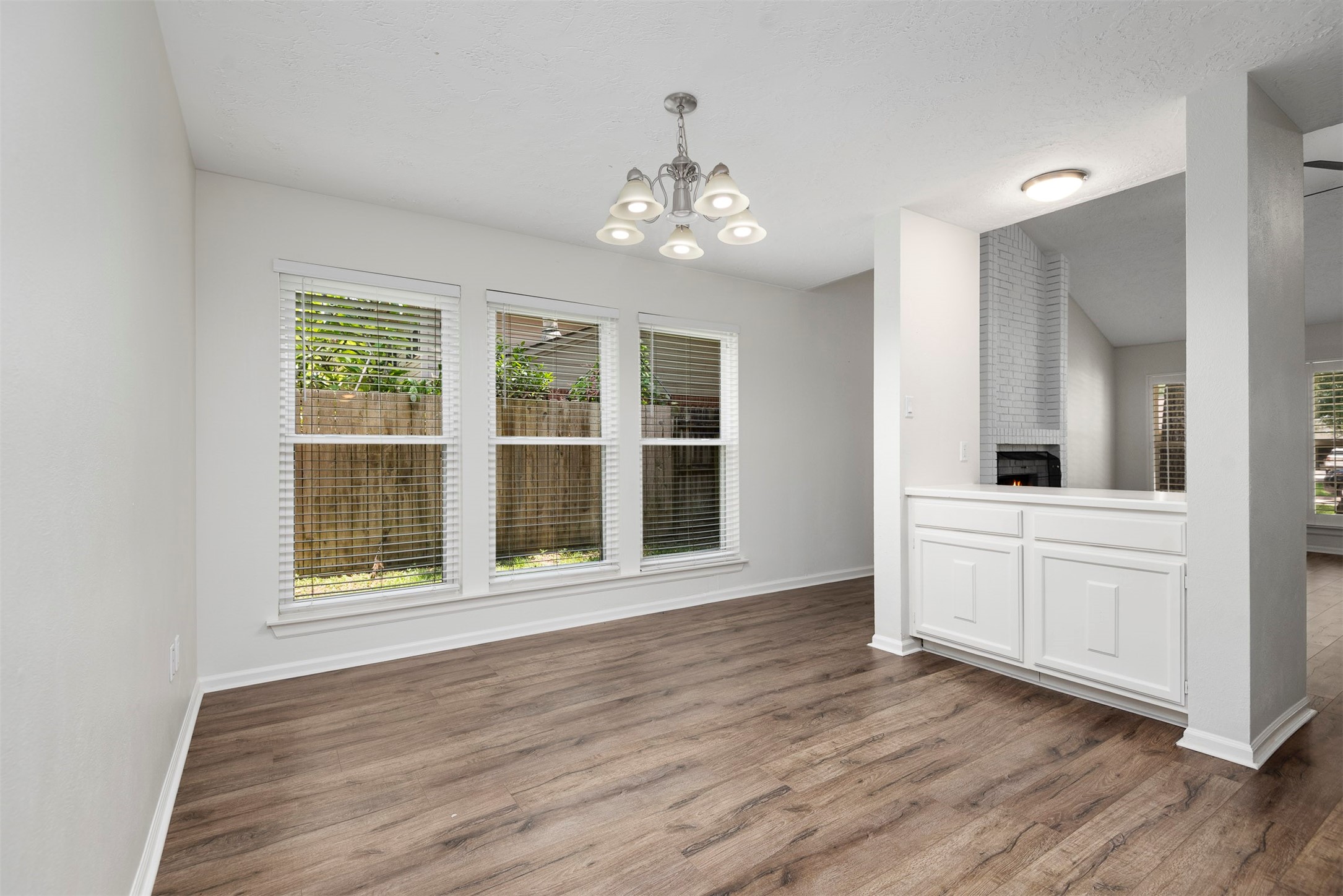 30 Berryfrost Lane The Woodlands, TX 77380 - Photo 15 of 33 a view of an empty room with wooden floor and a window